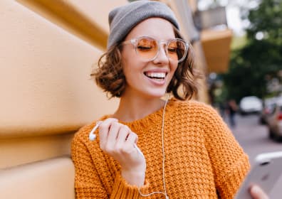 Happy woman watching online courses on a smartphone