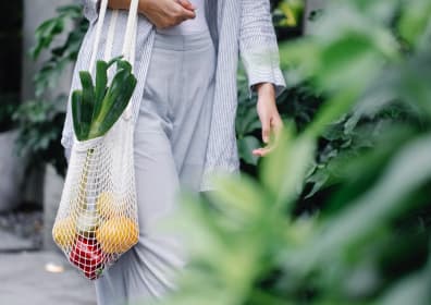 Woman carrying a bag of vegetables